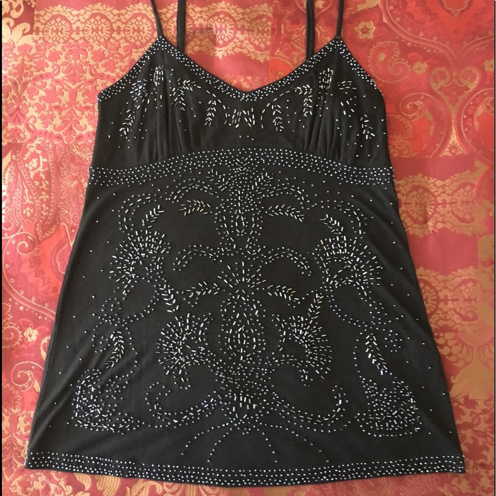 Black sequined tank top with adjustable straps.